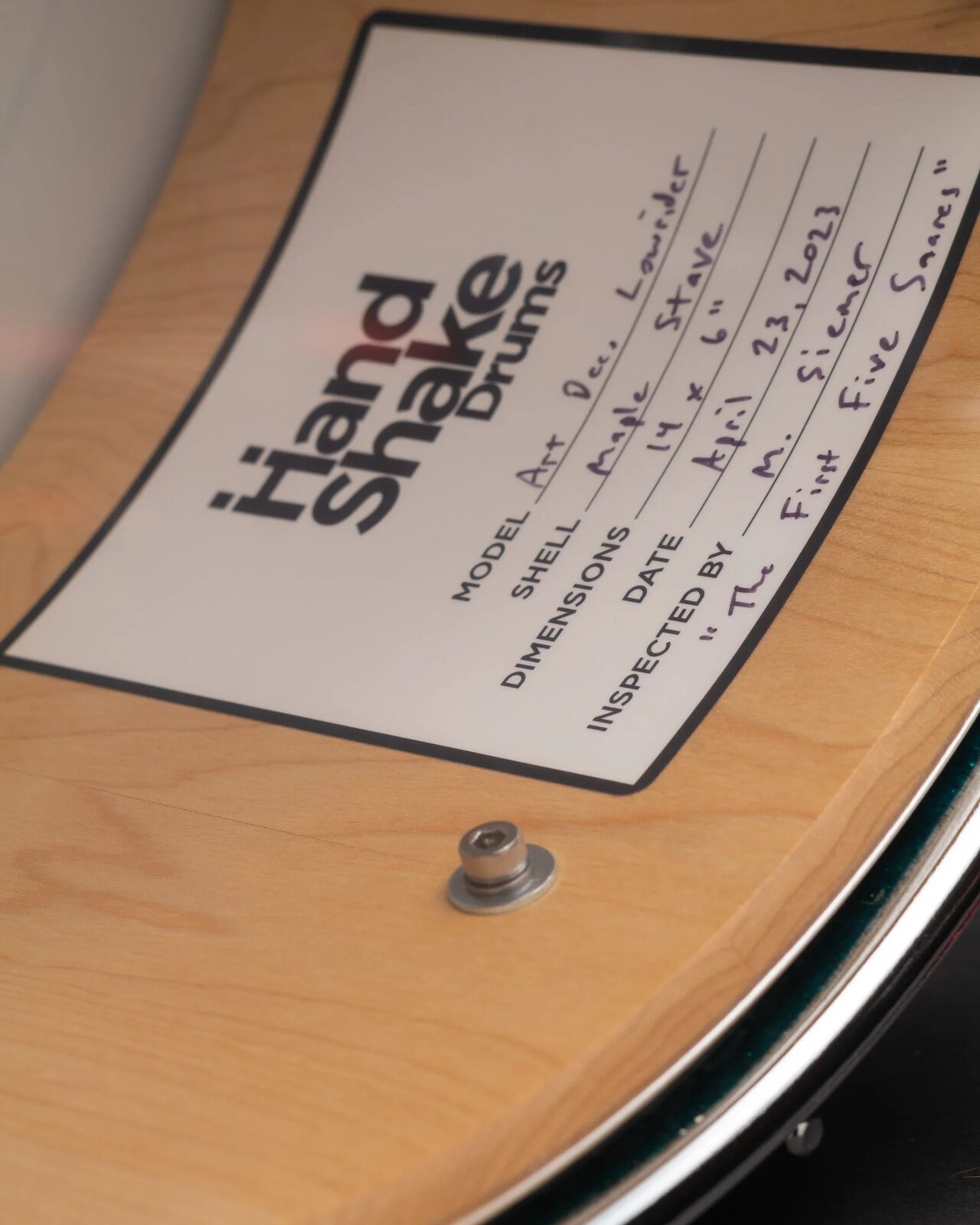 A HandShake inspection card signed by Matt Siemer inside a finished snare